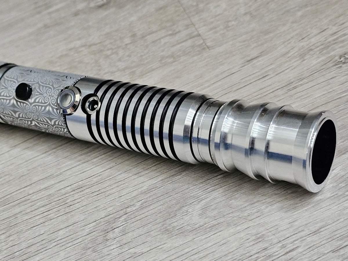 Custom silver lightsaber hilt inspired by Luke Skywalker, featuring etched designs and grooves