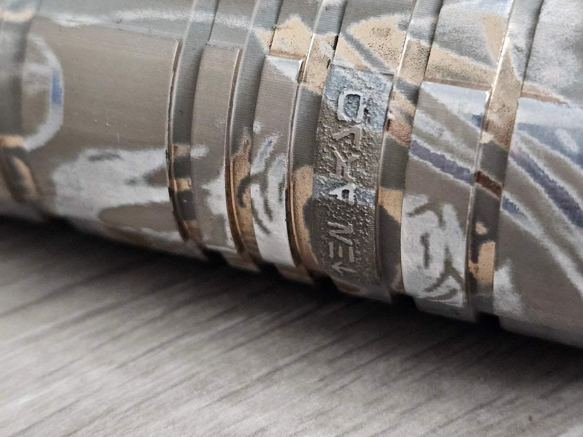 Close-up of a custom acid-etched lightsaber hilt inspired by Cal Kestis from Star Wars.