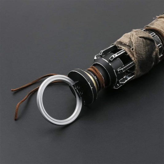 Close-up of Cal Kestis lightsaber hilt with weathered detailing and leather wrap on black background